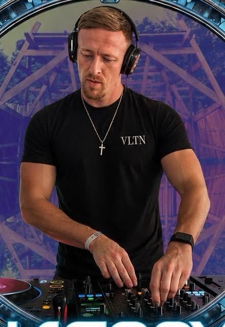 JAENOX performing at a festival with rollercoaster backdrop